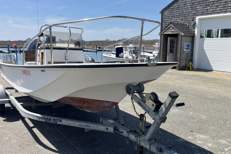 Slide: The Image of 1983 Boston Whaler 17 Montauk boat on trailer at marina, sunny day. - 5