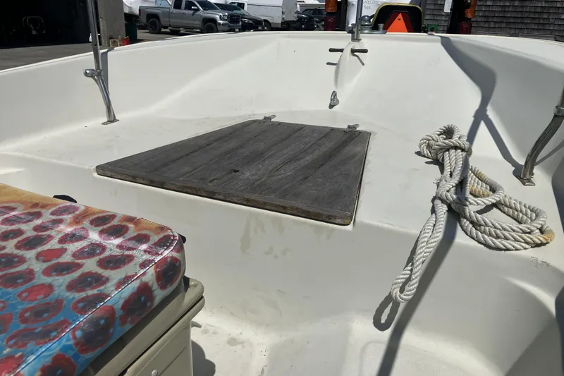 Slide: The Image of 1983 Boston Whaler 17 Montauk interior with rope and colorful seat cushion. - 9