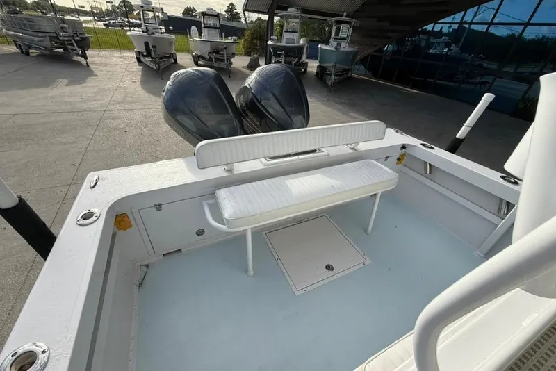Slide: The Image of 2012 Custom 32 CC boat with dual engines and seating, docked outdoors. - 11