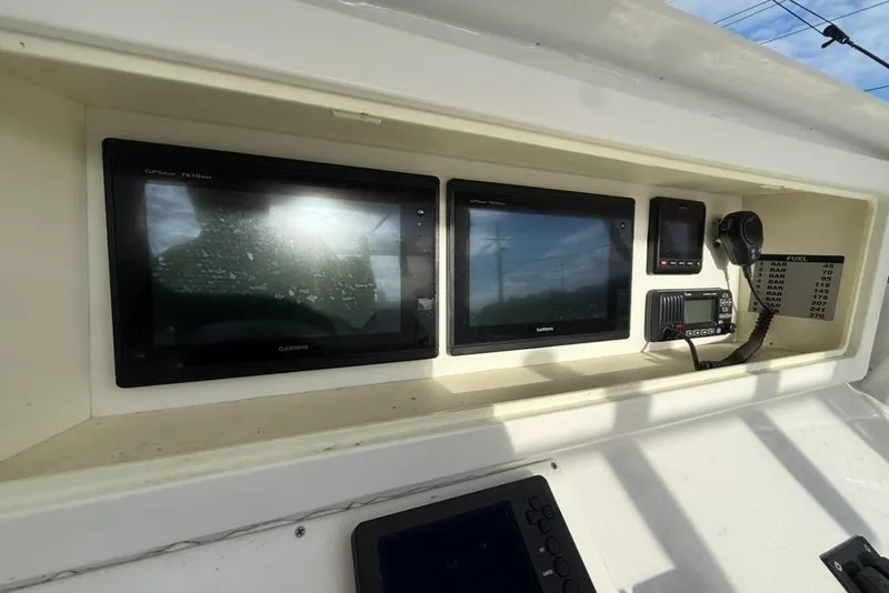 Slide: The Image of Boat dashboard with Garmin GPS displays and communication equipment, Custom 32 CC, 2012 model. - 16
