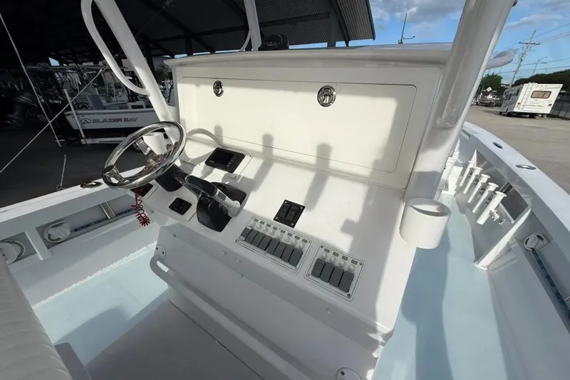 Slide: The Image of Center console of a 2012 Custom 32 CC boat with steering wheel and controls. - 17