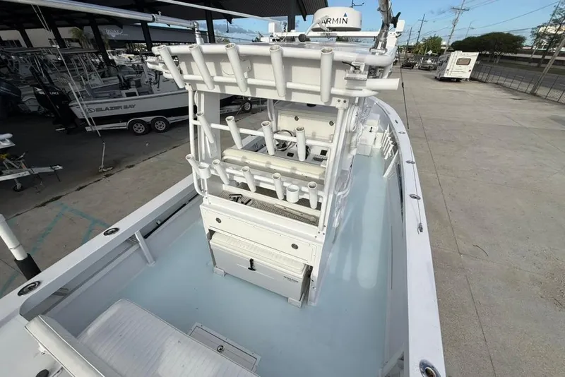 Slide: The Image of 2012 Custom 32 CC boat with rod holders and Garmin equipment, docked at a marina. - 19