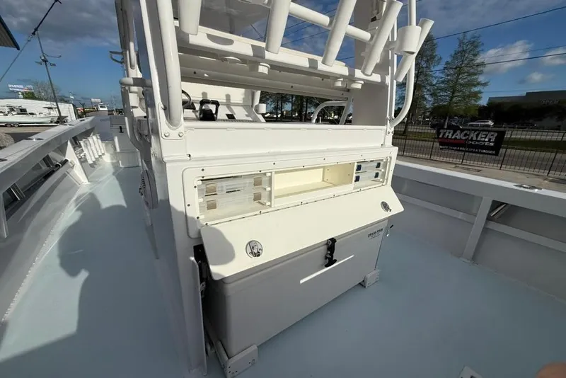 Slide: The Image of 2012 Custom 32 CC boat deck with storage compartments and rod holders under a clear sky. - 20