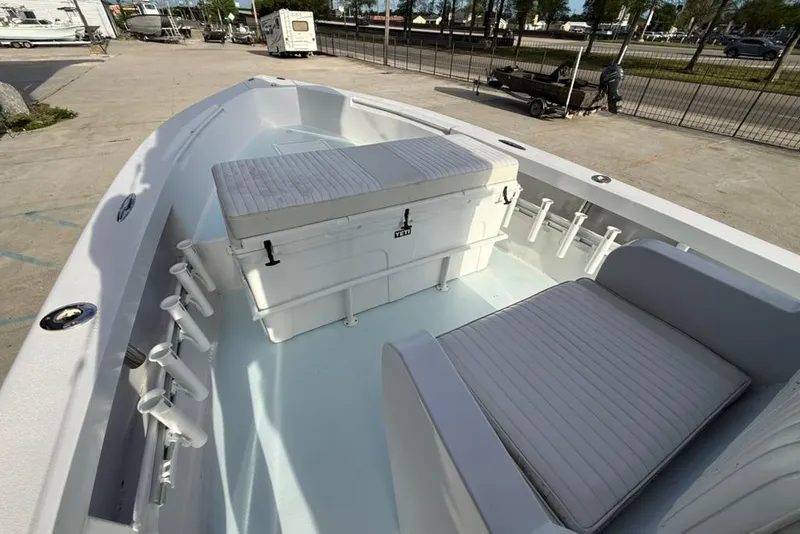 Slide: The Image of 2012 Custom 32 CC boat interior with seating and storage, docked outdoors. - 22