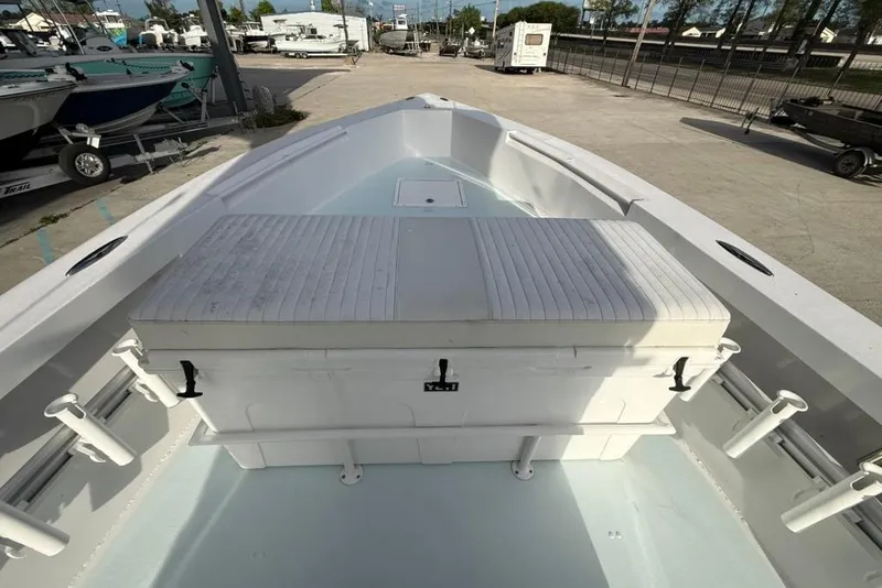 Slide: The Image of 2012 Custom 32 CC boat with seating and rod holders, docked in a marina. - 23