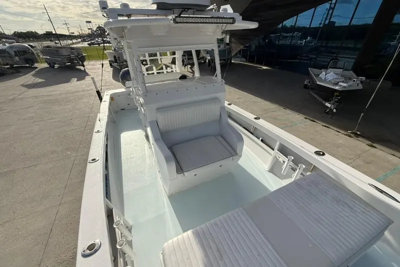 Slide: The Image of 2012 Custom 32 CC boat with spacious seating and modern design, docked outdoors. - 26