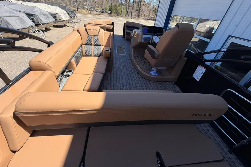 Slide: The Image of 2026 Harris Grand Mariner 250 SL pontoon boat with luxurious tan seating and modern helm. - 23