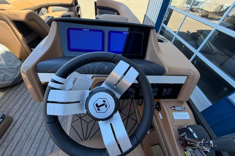 Slide: The Image of Steering console of 2026 Harris Grand Mariner 250 SL with dual Simrad displays. - 27