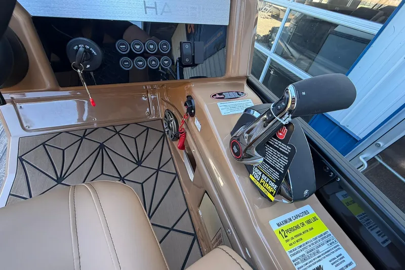 Slide: The Image of 2026 Harris Grand Mariner 250 SL boat dashboard with controls and seating. - 28