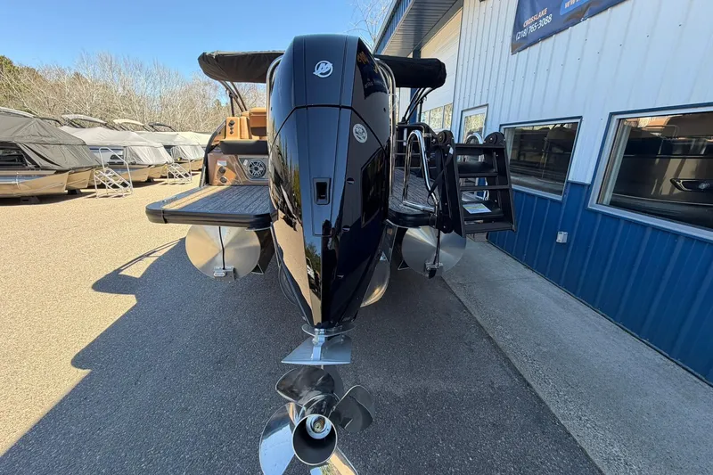 Slide: The Image of 2026 Harris Grand Mariner 250 SL pontoon boat with powerful outboard motor, docked outdoors. - 3