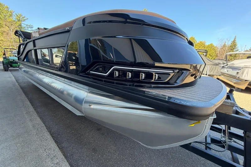 Slide: The Image of 2026 Harris Grand Mariner 250 SL pontoon boat with sleek black design on trailer. - 5