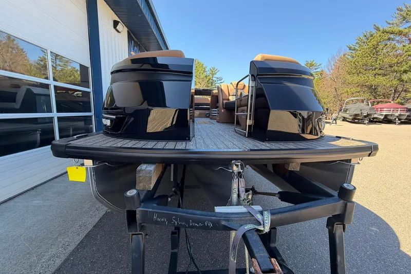 Slide: The Image of 2026 Harris Grand Mariner 250 SL pontoon boat on trailer, outdoor dealership setting. - 6