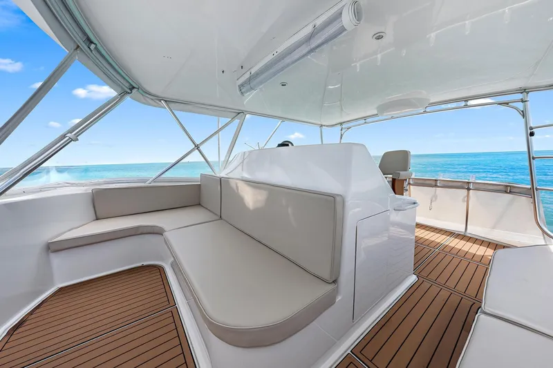 Slide: The Image of Luxurious 1998 Viking 55 Convertible yacht interior with sleek seating and ocean view. - 13