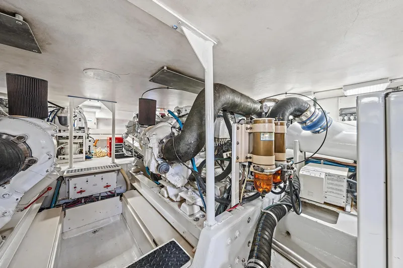 Slide: The Image of Engine room of a Viking 55 Convertible yacht, showcasing complex machinery and components. - 15