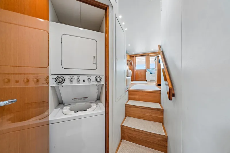 Slide: The Image of Laundry area and stairs inside a 1998 Viking 55 Convertible yacht. - 6