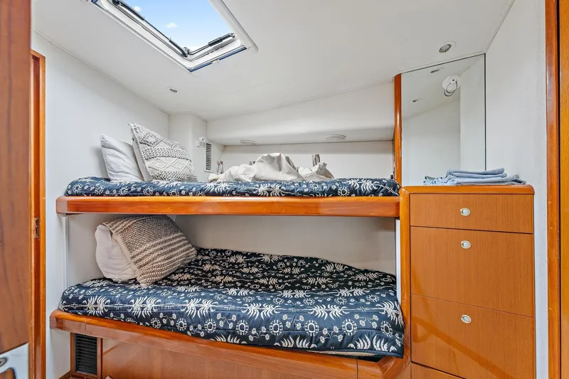 Slide: The Image of Bunk beds in 1998 Viking 55 Convertible yacht cabin with skylight and wooden cabinetry. - 7