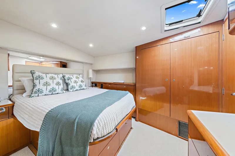 Slide: The Image of Luxurious bedroom interior of 1998 Viking 55 Convertible yacht with elegant wood finishes. - 8
