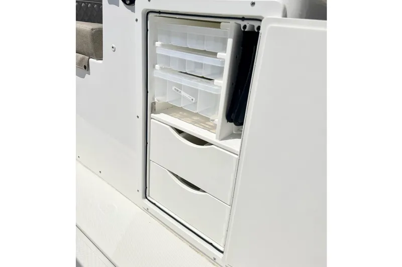 Slide: The Image of Storage compartment on 2026 Sea Hunt Ultra 285 Coffin Box boat with drawers and containers. - 14