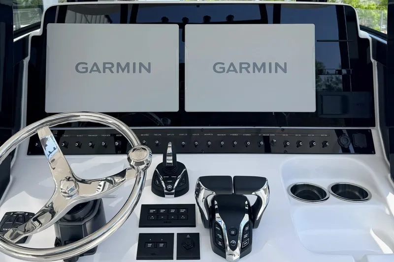 Slide: The Image of 2026 Sea Hunt Ultra 285 Coffin Box dashboard with Garmin displays and controls. - 16