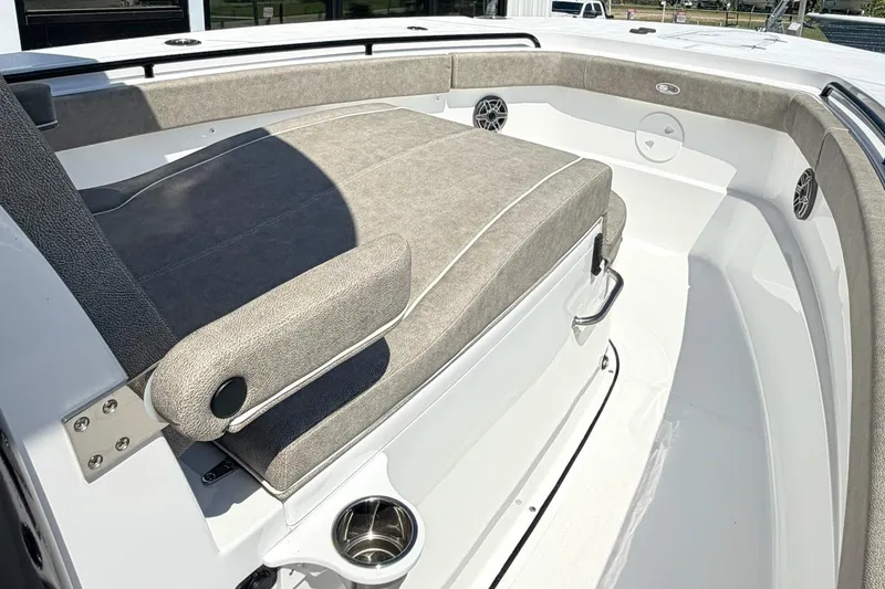Slide: The Image of 2026 Sea Hunt Ultra 285 Coffin Box boat interior with cushioned seating and cup holder. - 19