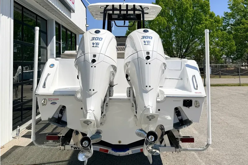 Slide: The Image of 2026 Sea Hunt Ultra 285 Coffin Box with twin 300 V6 engines, rear view. - 2