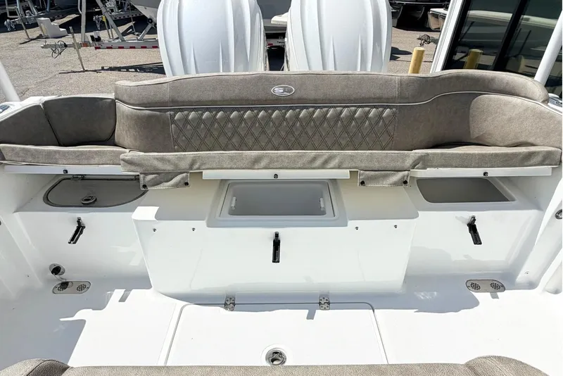 Slide: The Image of 2026 Sea Hunt Ultra 285 Coffin Box boat interior with cushioned seating and storage compartments. - 5