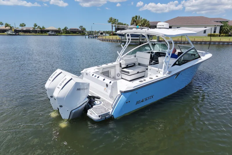 Slide: The Image of 2023 Blackfin 272 DC boat with dual Mercury engines on a calm lake. - 10