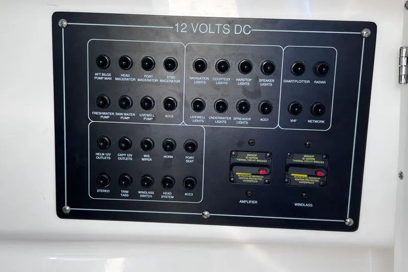 Slide: The Image of Control panel of a 2023 Blackfin 272 DC boat with labeled switches and circuit breakers. - 100