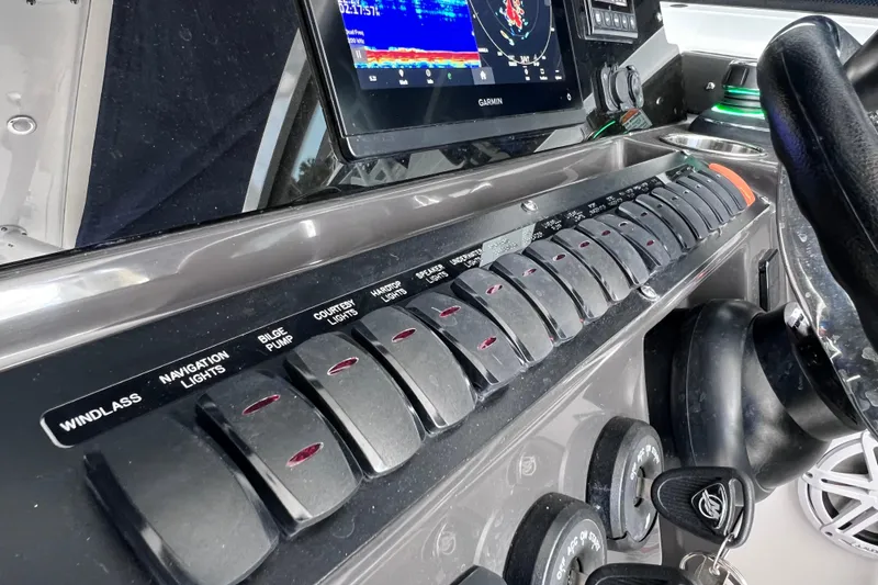 Slide: The Image of Control panel of 2023 Blackfin 272 DC boat with navigation and system switches. - 103