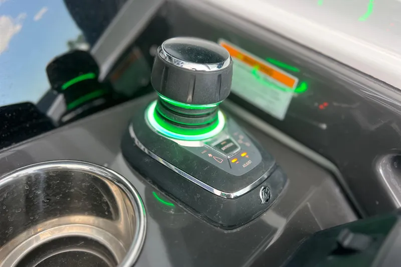 Slide: The Image of Control panel of 2023 Blackfin 272 DC boat with illuminated joystick and cup holder. - 106
