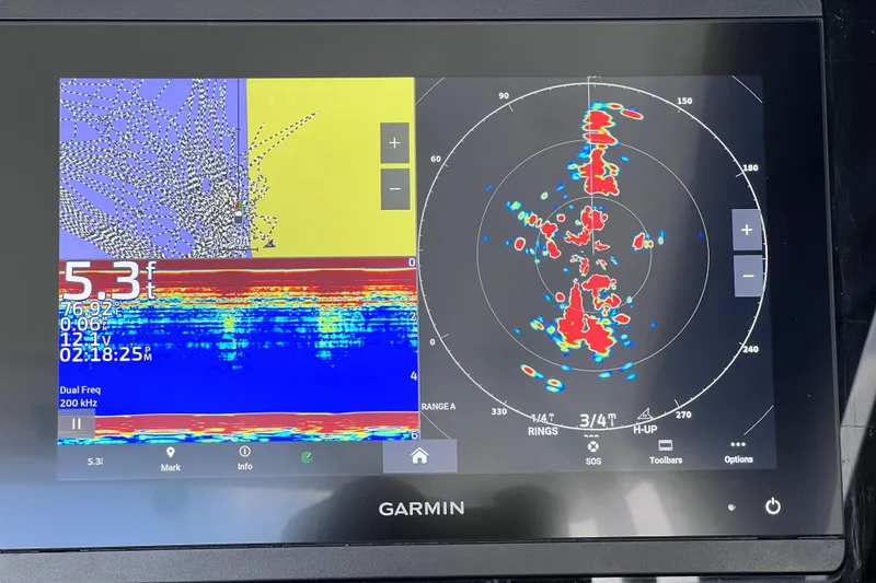Slide: The Image of Garmin marine display showing sonar and radar data on Blackfin 272 DC, 2023 model. - 107