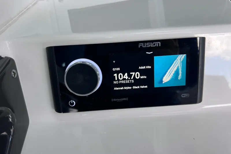 Slide: The Image of Fusion stereo display on 2023 Blackfin 272 DC boat, showing radio station 104.7 MHz. - 113