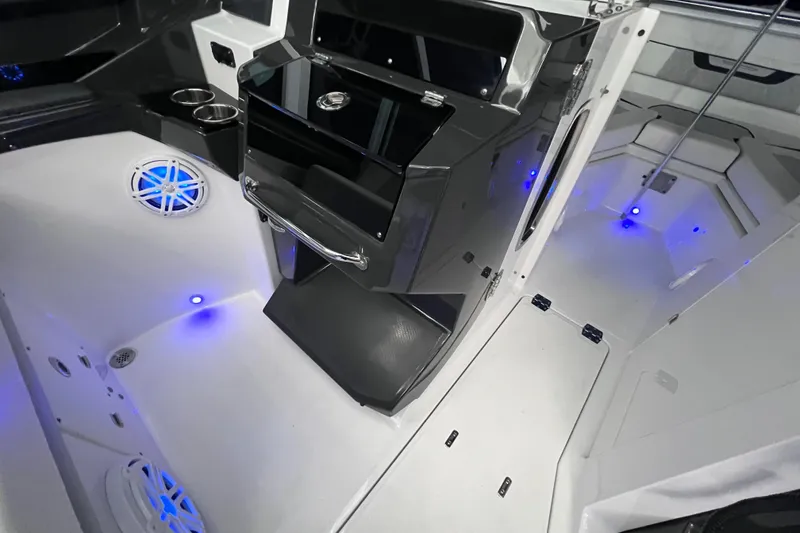 Slide: The Image of 2023 Blackfin 272 DC boat interior with sleek design and blue LED lighting. - 115