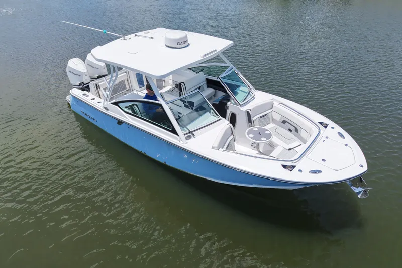 Slide: The Image of 2023 Blackfin 272 DC boat on water, featuring sleek design and spacious seating. - 13