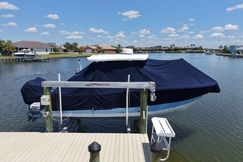 Slide: The Image of 2023 Blackfin 272 DC boat covered and docked on a sunny day. - 17