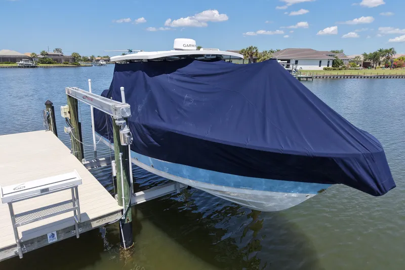 Slide: The Image of 2023 Blackfin 272 DC boat covered and docked on a sunny day. - 18