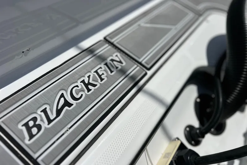 Slide: The Image of Close-up of 2023 Blackfin 272 DC boat logo and deck details. - 24
