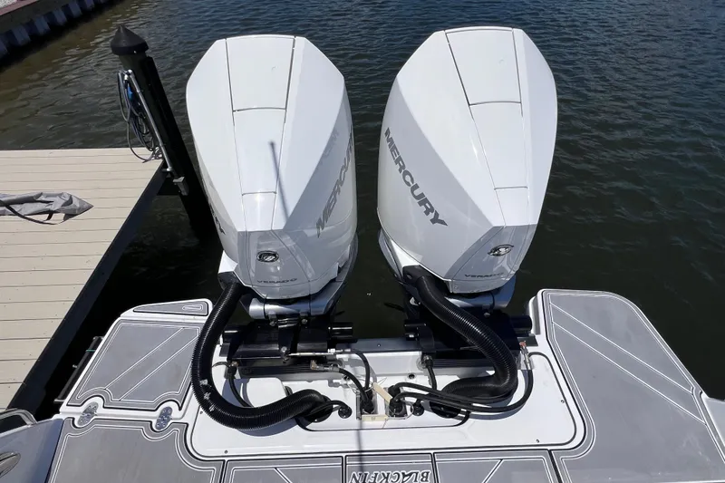 Slide: The Image of 2023 Blackfin 272 DC boat with dual Mercury outboard engines docked on water. - 27