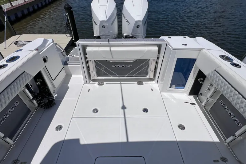 Slide: The Image of 2023 Blackfin 272 DC boat deck with seating, storage, and twin Mercury engines. - 28