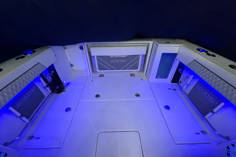 Slide: The Image of 2023 Blackfin 272 DC boat interior with blue LED lighting and sleek design. - 29