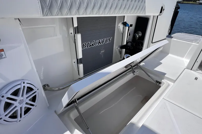 Slide: The Image of 2023 Blackfin 272 DC boat interior with storage compartment and speaker. - 35