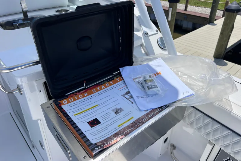 Slide: The Image of 2023 Blackfin 272 DC boat with quick start guide and owner's manual on deck. - 37
