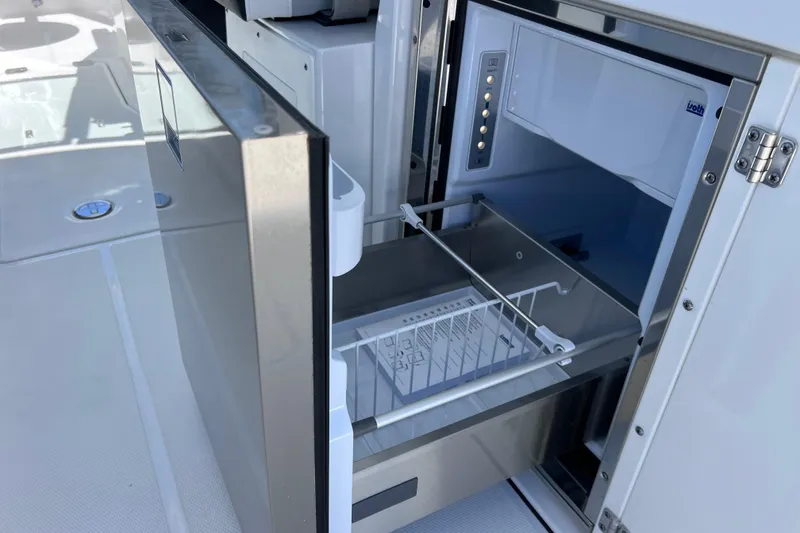 Slide: The Image of Open refrigerator on 2023 Blackfin 272 DC boat, showcasing modern interior design. - 39