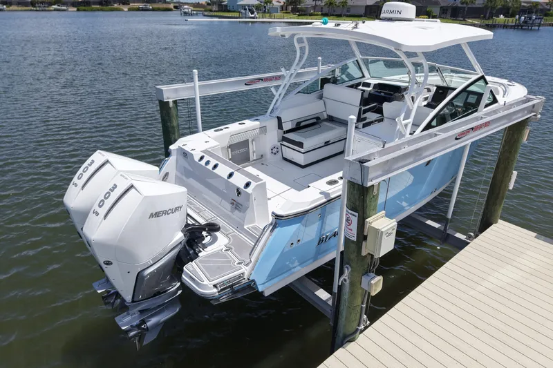 Slide: The Image of 2023 Blackfin 272 DC boat docked with twin Mercury engines. - 4