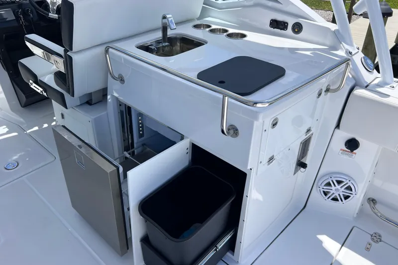 Slide: The Image of 2023 Blackfin 272 DC boat interior with sink, storage, and seating area. - 40