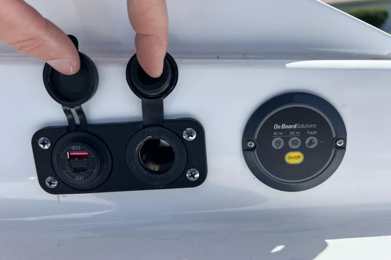 Slide: The Image of 2023 Blackfin 272 DC boat dashboard with USB ports and power controls. - 41
