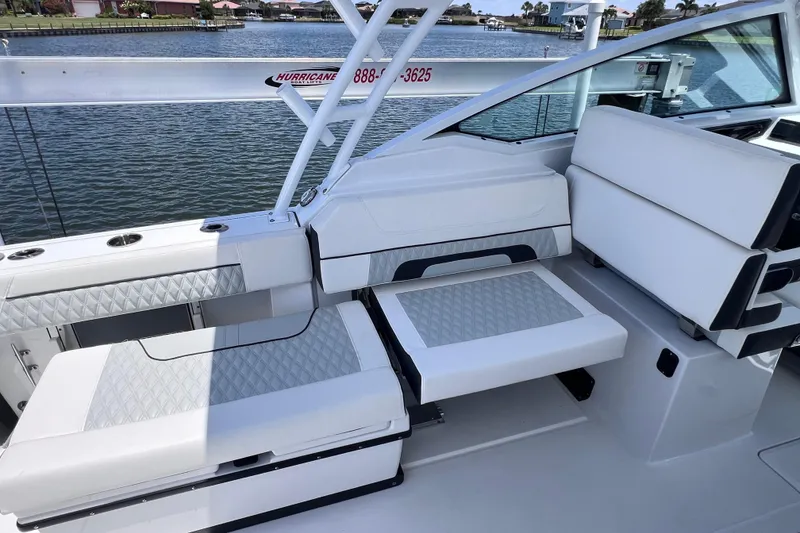 Slide: The Image of 2023 Blackfin 272 DC boat interior with white cushioned seating by the water. - 43