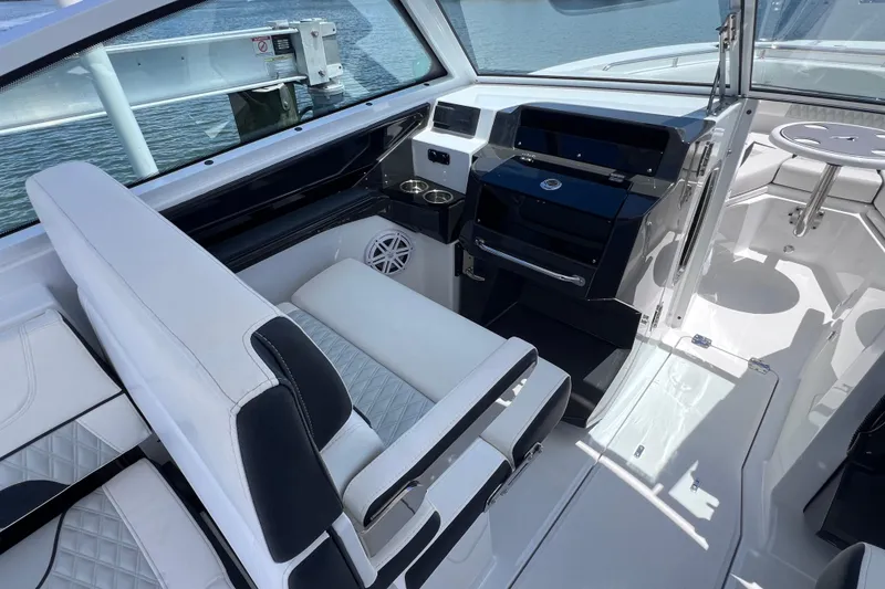 Slide: The Image of 2023 Blackfin 272 DC boat interior with white seating and modern dashboard design. - 45