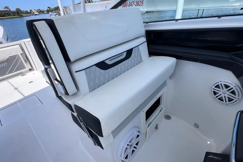 Slide: The Image of 2023 Blackfin 272 DC boat interior with white seating and speaker system. - 47