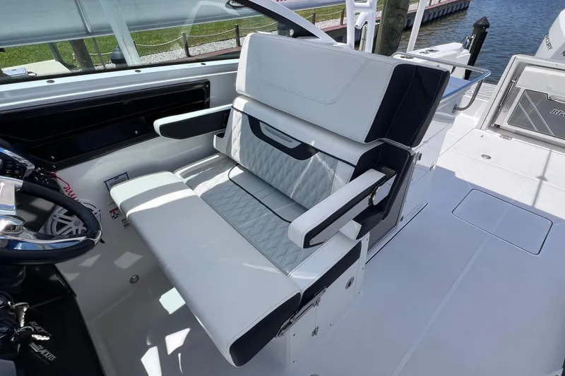 Slide: The Image of Luxurious seating on 2023 Blackfin 272 DC boat, featuring elegant white and black upholstery. - 49